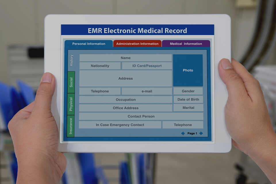 Electronic medical record application showing blank patient information on digital tablet screen in someone hands.